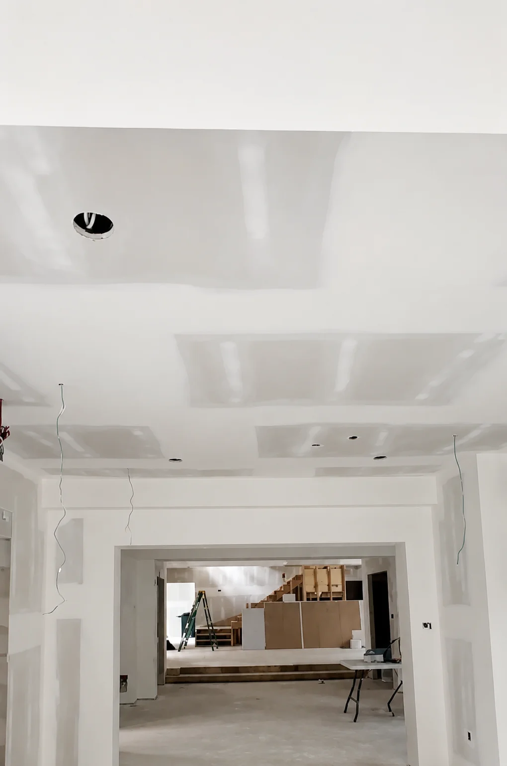 Drywall taping and mudding in a renovated room